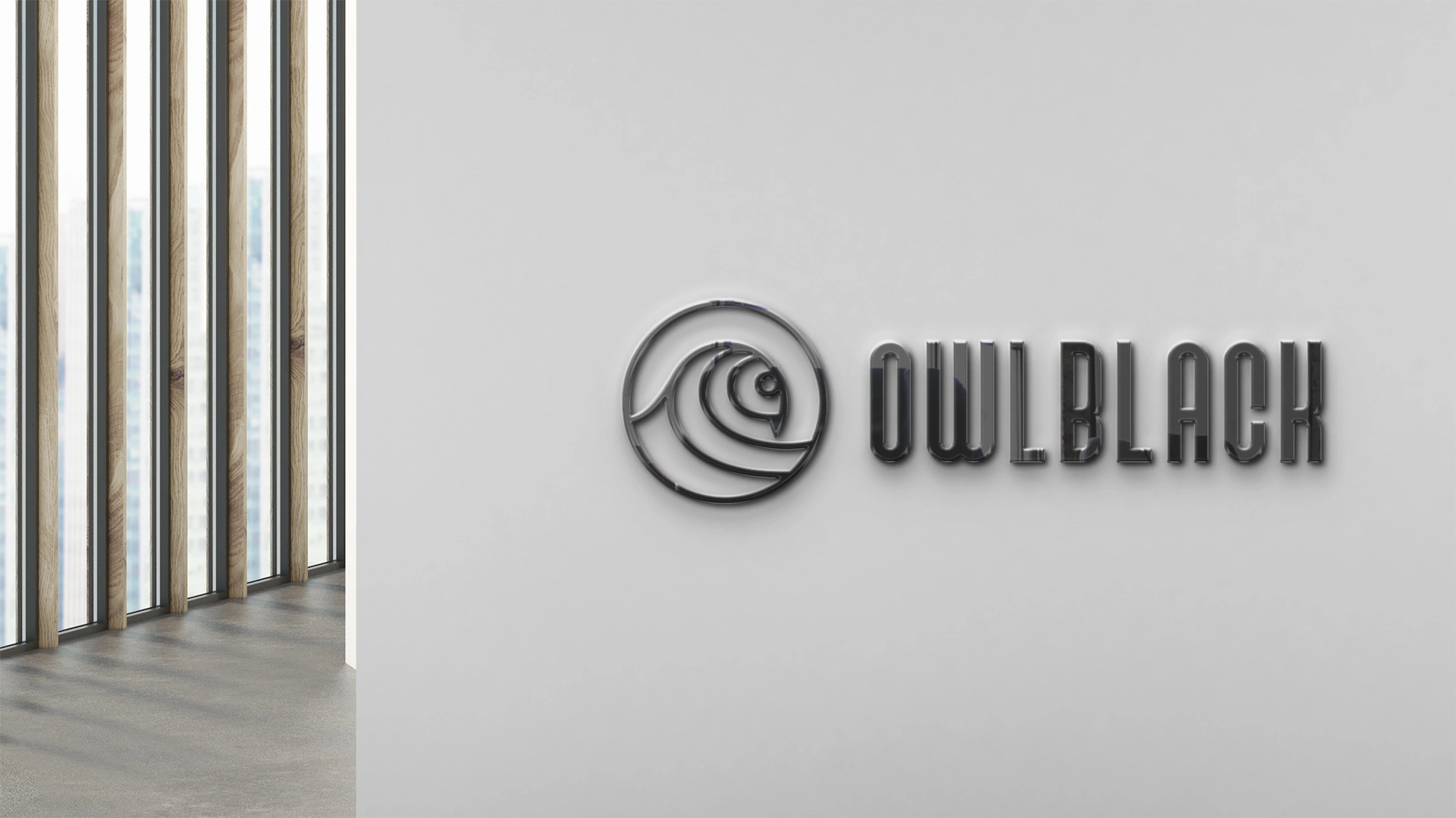 Logo Owlblack en relief sur un mur de l'agence