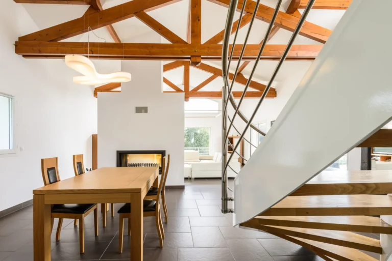 Intérieur sous charpente en bois avec escalier hélicoïdal, réalisation Castors Basques